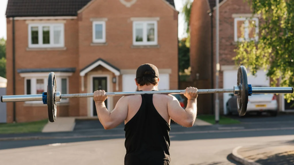 Fit bodybuilder squatting with barbell, emphasizing muscle-building protein needs.