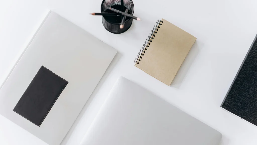 Netbook and planner on desk for organizing tasks - How to be more productive