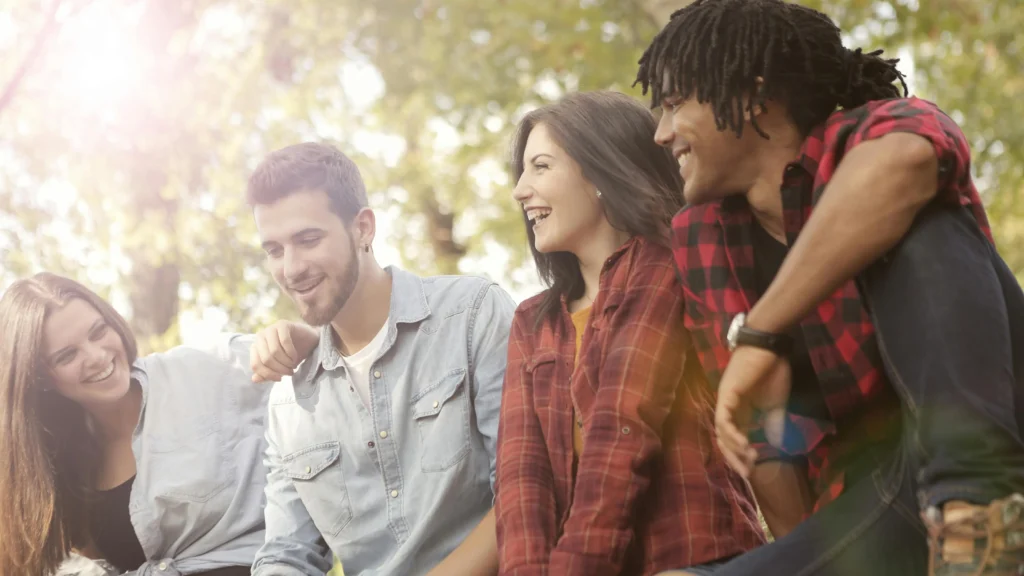 Group of friends laughing outdoors, illustrating how to increase dopamine through social connections