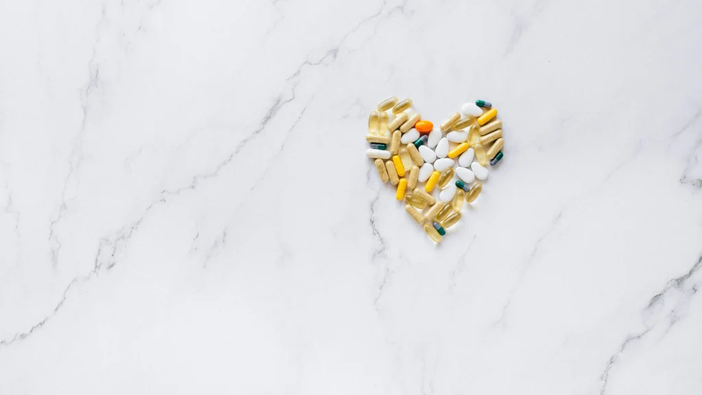 Heart-shaped pills and medicines demonstrating how to increase dopamine with supplements