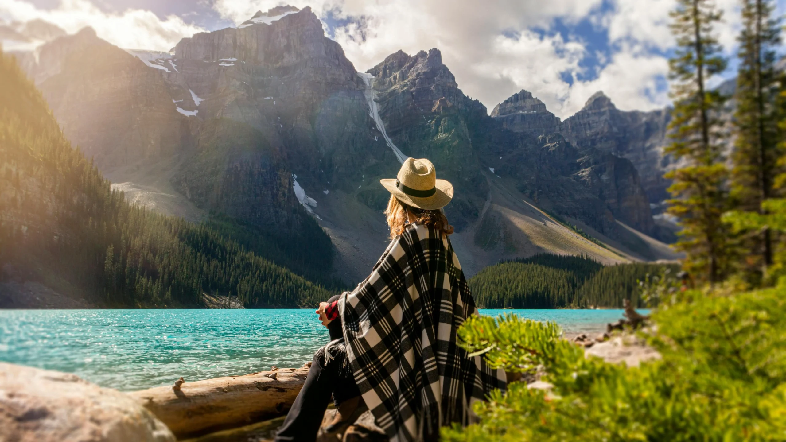 Woman meditating by a lake to improve mental focus