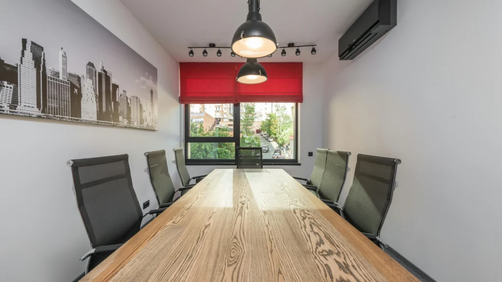 Modern workspace with city photo, desk, lamps, and armchairs in daylight illustrating productivity methods