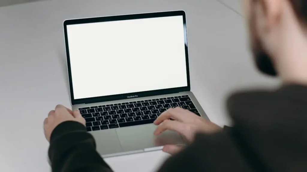 Person working on a MacBook Air, illustrating 5 ways to increase productivity.