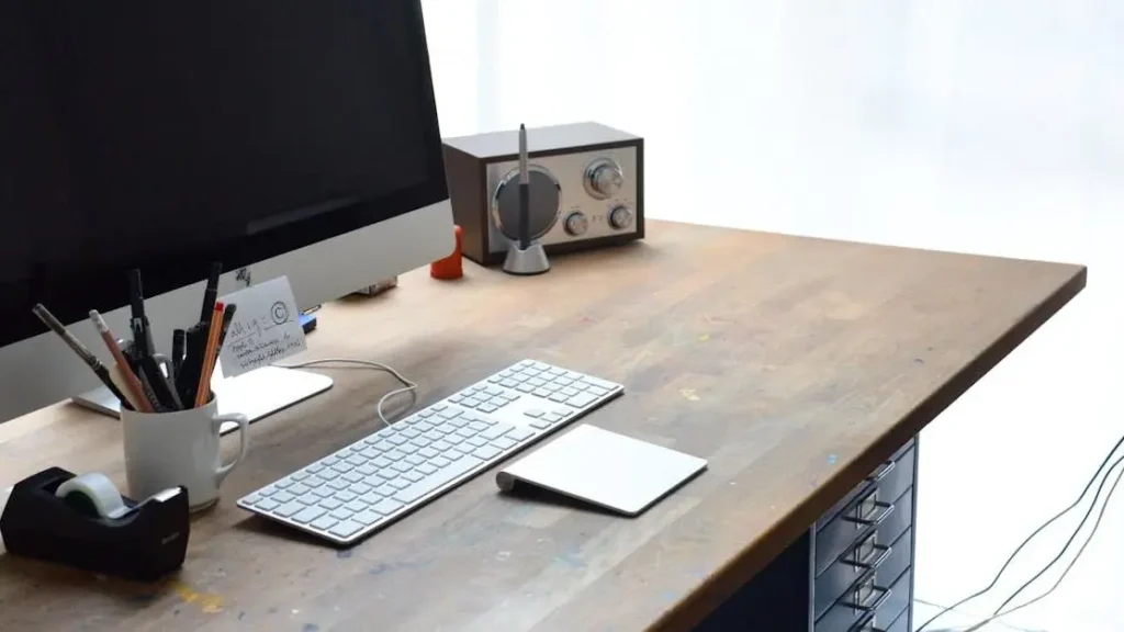 Modern workspace setup with computer and radio, illustrating how to be more productive in life