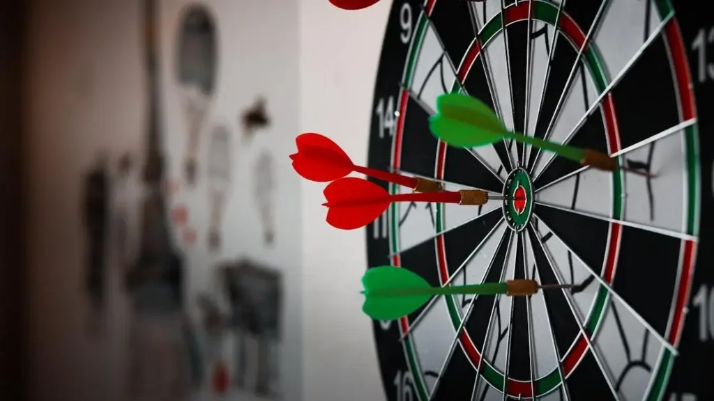 Dartboard with dart pins, representing how to focus better at work.