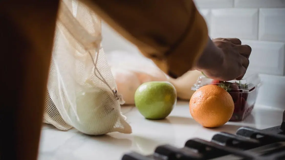 Unpacking fruits and a tub of protein powder on kitchen counter for weight gain diet