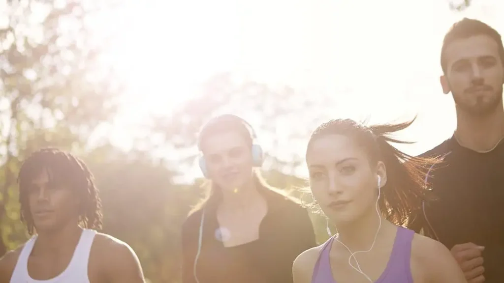 Young multiracial group running together in the park, showcasing types of workouts