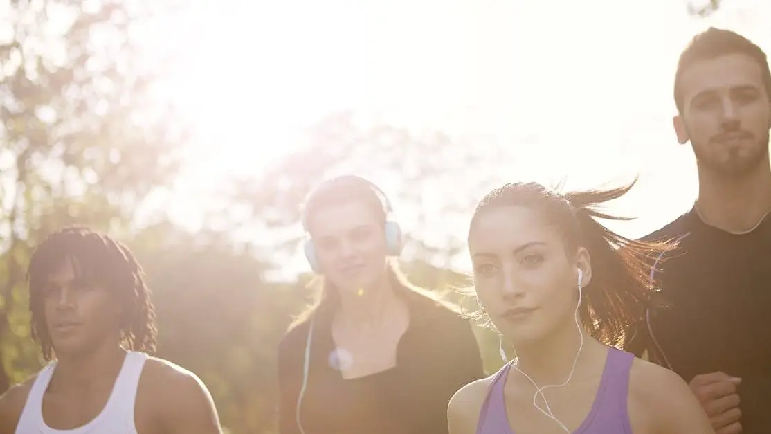 Young multiracial group running together in the park, showcasing types of workouts